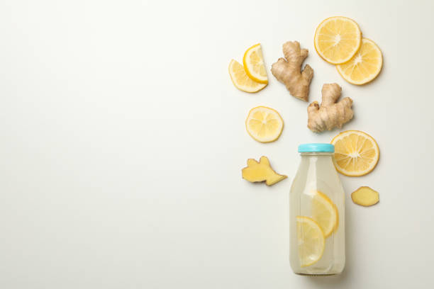 istock Bottle of ginger lemon water on white background 1282541133