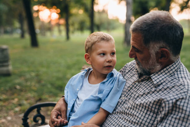 istock grandfather with his grandson in public park 1282542930