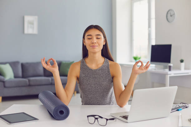 istock Relaxed business lady sitting at desk in her office taking break from work and practicing meditation 1282548050