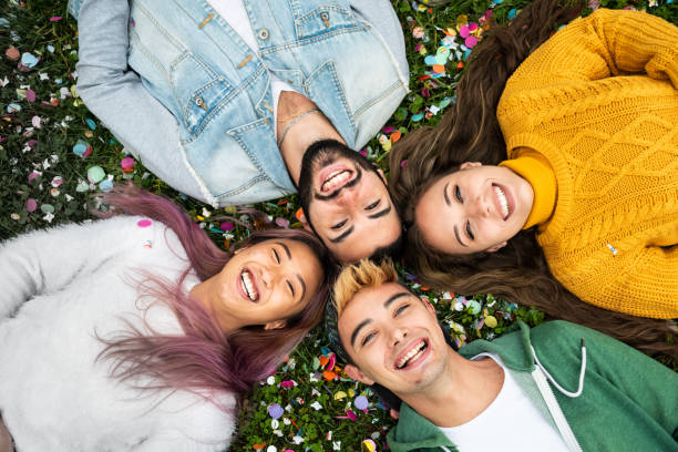 istock Happy group of friends lying on the grass. 1282548185