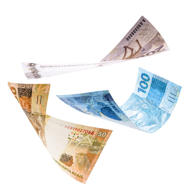 istock two hundred, one hundred and fifty reais notes in fall, isolated white background. Concept of big loss, inflation and devaluation 1282549420