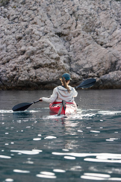 istock Woman paddling towards rocks 1282549426