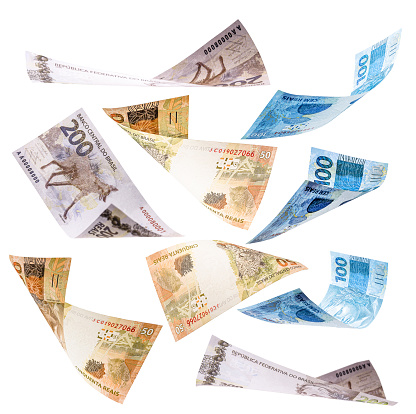 several banknotes from brazil falling on white background, 200, 100 and 50 reais falling