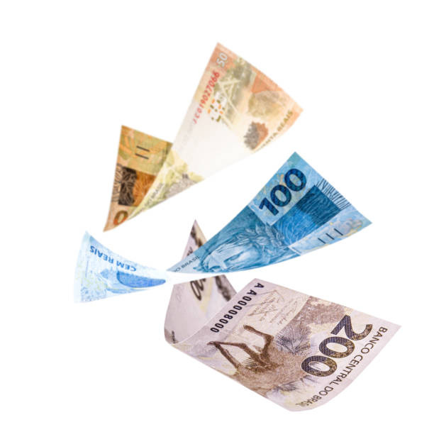 istock two hundred, one hundred and fifty reais notes in fall, isolated white background. Concept of big loss, inflation and devaluation 1282549526