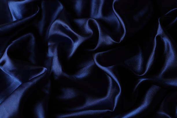 istock drapery of dark blue glossy fabric 1282549569