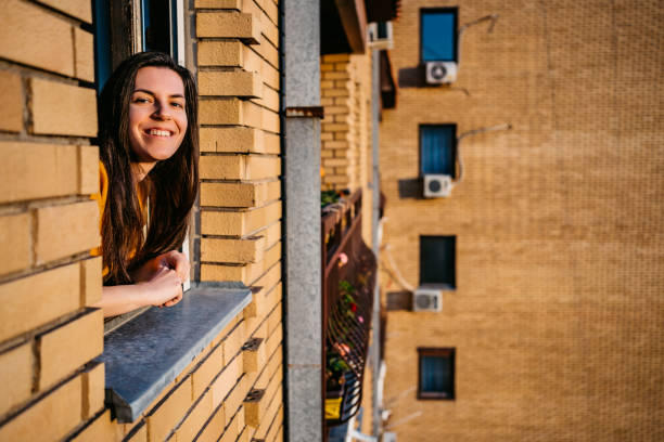 istock Woman enjoying in sun at window 1282551757