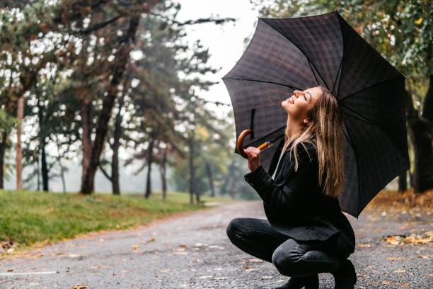 istock Attractive young lady holding umbrella 1282553680