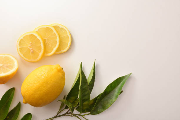 istock Cut and sliced organic lemon on a white table top 1282557921