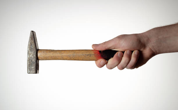 istock Hammer in mans haond on white background. 1282558433