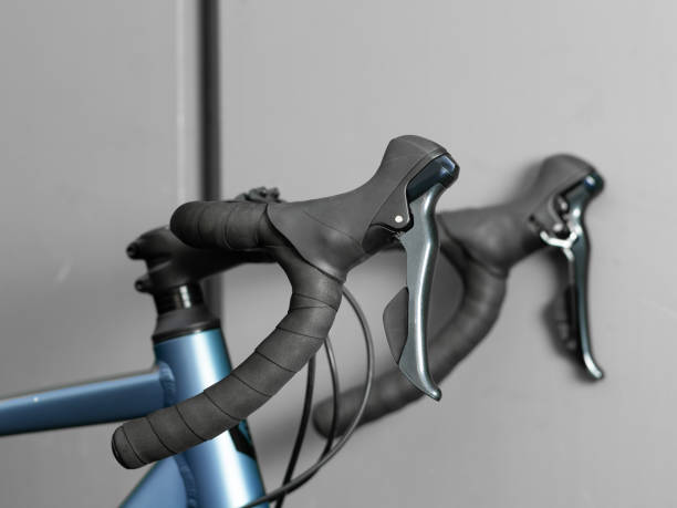 istock Road bike handle bar on grey background. Close up. 1282558468