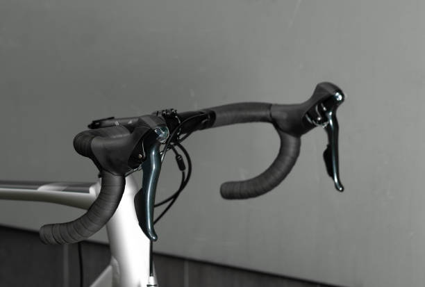 istock Road bike handle bar on grey background. Close up. 1282558884