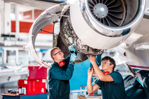 istock Aircraft mechanics working on a jet engine in the airplane hangar 1282559235