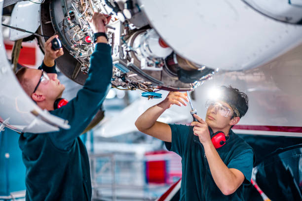 istock Two young engineers checking a jet engine in the airplane hangar 1282560464