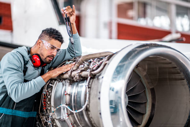 istock Male aircraft engineer works on the jet engine 1282560674