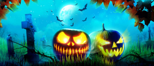 istock Halloween pumpkin face with burning fire inside in the graveyard. 1282560717