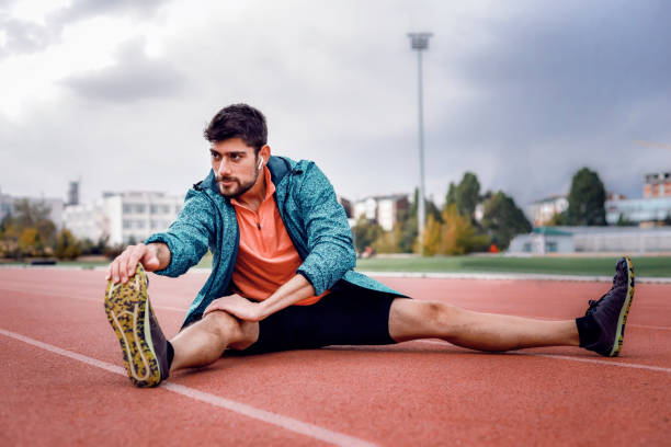 istock Shot of a handsome young man warming up before his workout. 1282560980