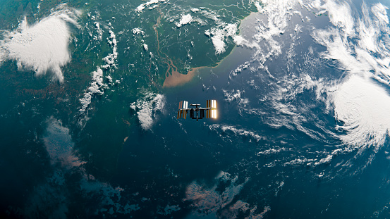 La Estación Espacial Internacional (ISS) Orbita en el espacio sobre el río Amazonas - SpaceX & NASA Research - 3D Rendering photo