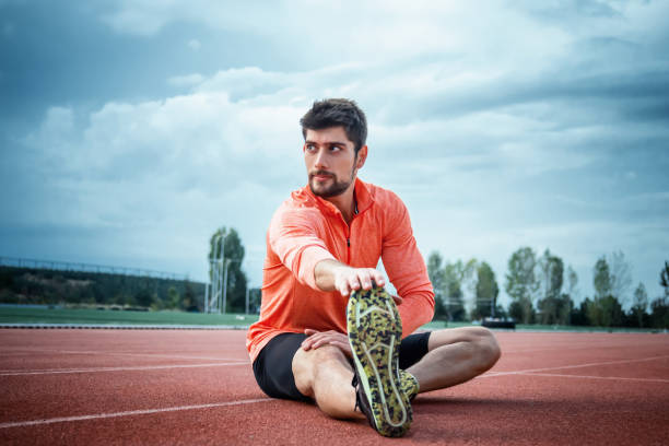 istock Shot of a handsome young man warming up before his workout. 1282561230