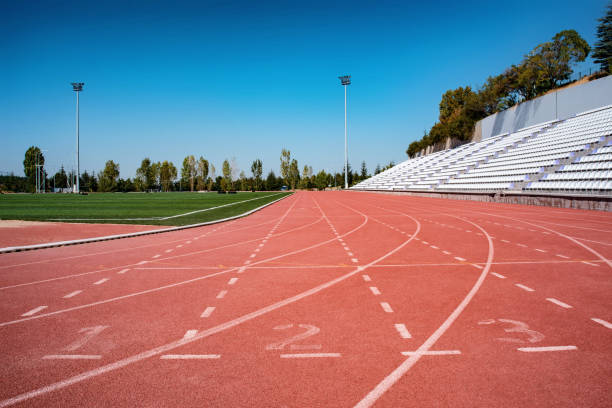 istock Starting line at empty track and field stadium 1282561853