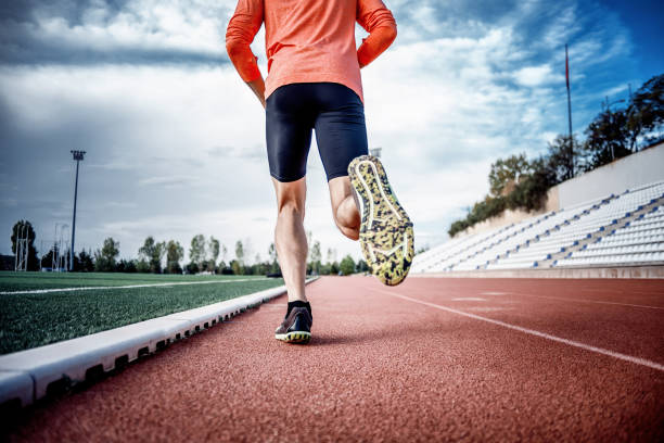 istock A young male running on track and field 1282561865