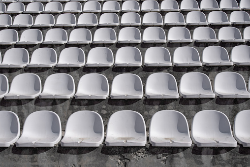 Empty white plastic stadium seats