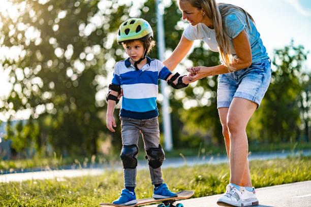 istock Mom helps a son to drive a skateboard 1282562224