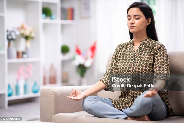 Woman At Home Sofa Sitting Stock Photo Stock Photo - Download Image Now - Women, Meditating, India
