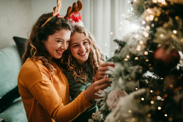 Decorate Christmas tree with your daughter