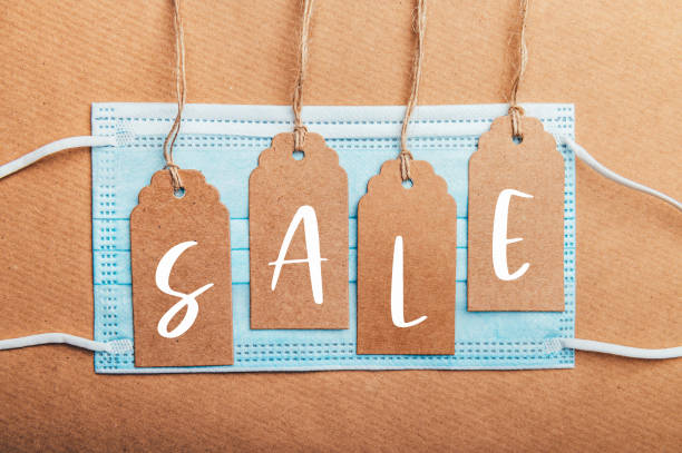istock Sale text on price tags with face mask 1282564608