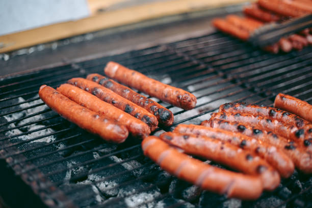istock Delicious fresh hot dogs on the grill 1282566027