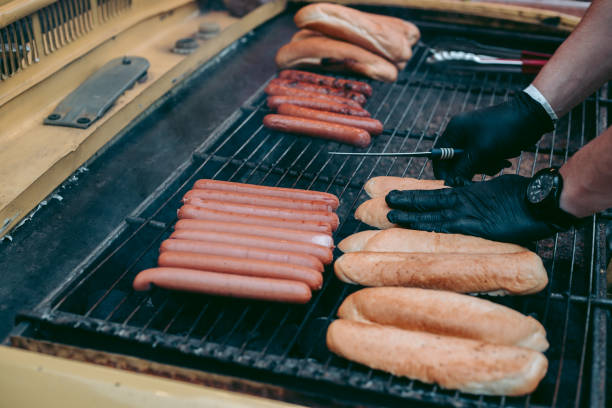istock Delicious fresh hot dogs on the grill 1282566081