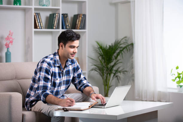 istock Young man sofa sitting at home - stock photo 1282566104