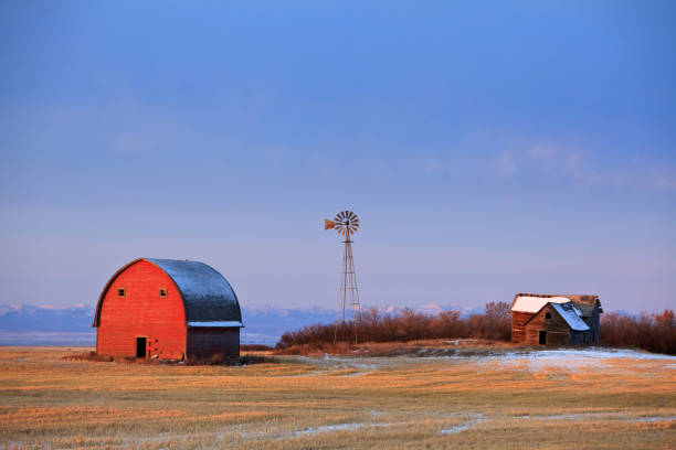 istock Old Abandoned Farm With Red Barn and Windmill on the Great Plains 1282567932