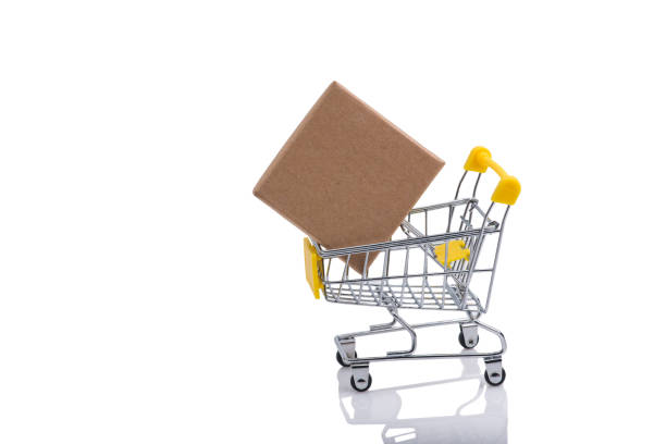 istock Paper box in a shopping cart isolated on white background. 1282574252