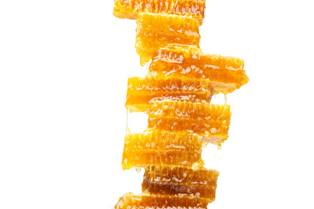 istock Pyramid of fresh bee comb honey on white background 1282577232
