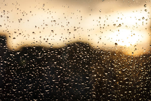 istock raindrops on the window glass, sunset, evening in the city 1282579402