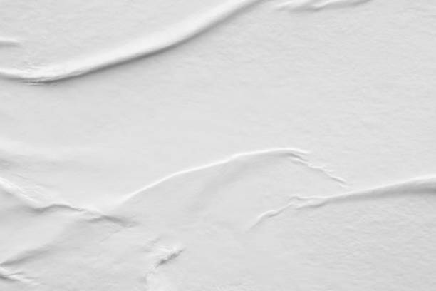 istock Blank white crumpled and creased paper poster texture background 1282580781