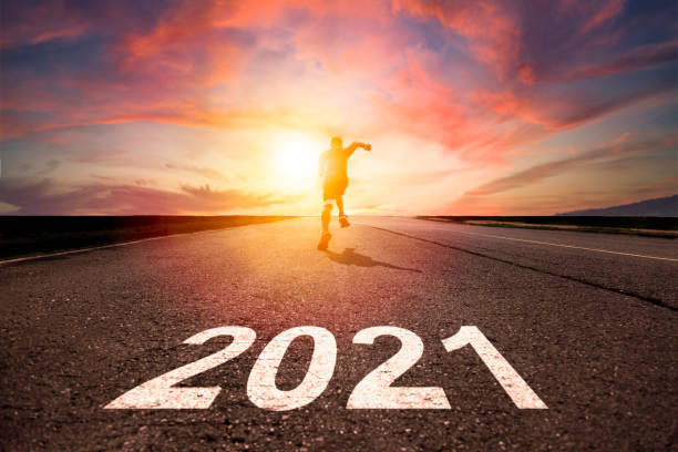 istock man running and sprinting on road with celebration 2021 new year concept 1282584472