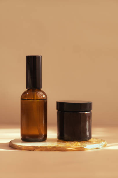 istock Brown glass cosmetic bottle on minimalist background 1282584891