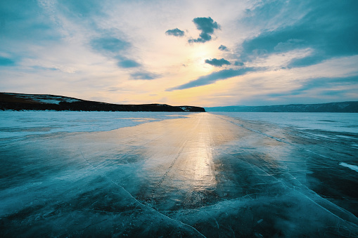 Panoramic image of frozen lake at frosty temperature during winter sunrise in Germany