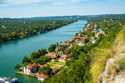Summer Landscape of Mount Bonnell views of Water front Drive Hansion homes and Pennybacker Bridge - Mount Bonnell Cliffside Colorado River overlook with colorful rooftop along the waterfront mansion properties