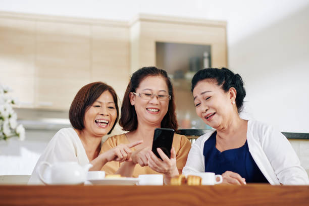 istock Senior women watching funny videos 1282589429