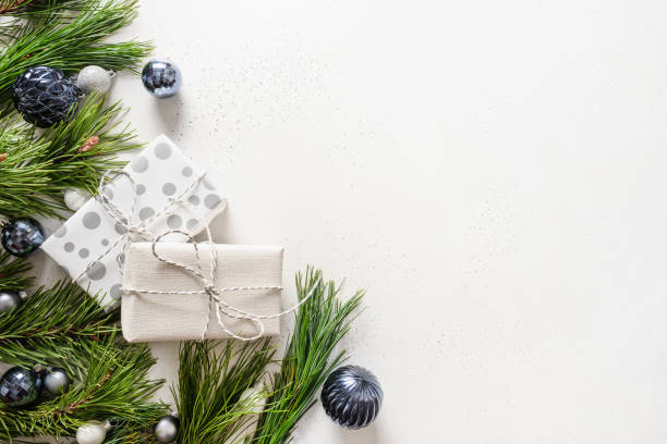 istock Christmas holiday composition with blue baubles and evergreen branches on white. 1282589630