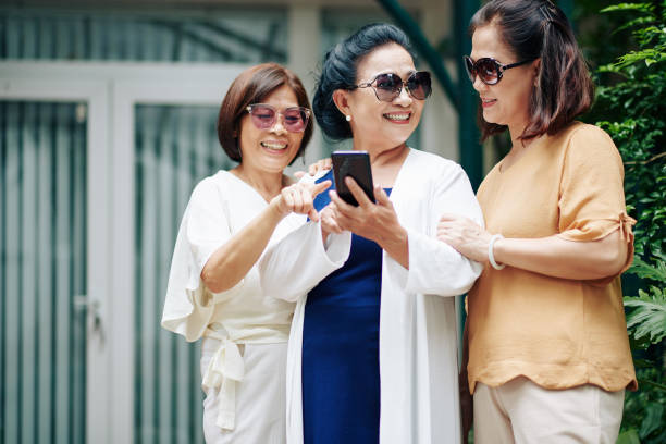 istock Senior woman choosing photos 1282589769
