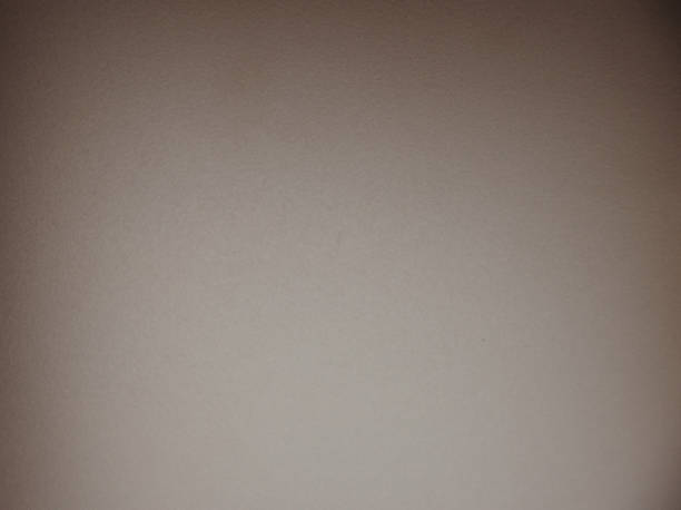 istock Monochrome brown surface with rough texture and vignetting around the edges. 1282593643