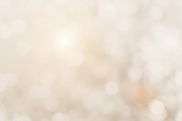 istock Cream blurred christmas lights background. Design effect focus happy holiday party glow texture white wallpaper bokeh sun sunny star shiny soft plain warm flare blur night light new year. 1282596133