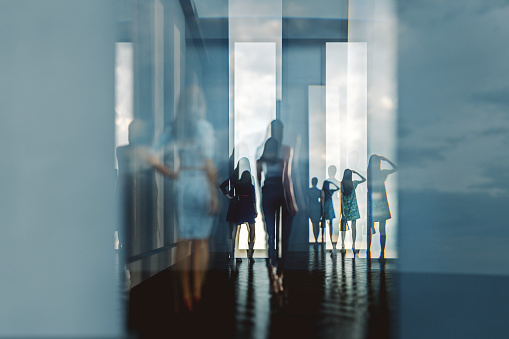 Abstract women silhouettes against glass