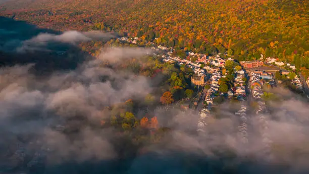 Photo of Sunny early morning in the Pocono Mountains with low clouds over the historical town Jim Thorpe in the colorful autumn season. Pennsylvania, Carbon County.