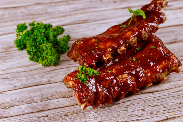 istock Beef ribs with barbecue and knife on wooden board. 1282603270