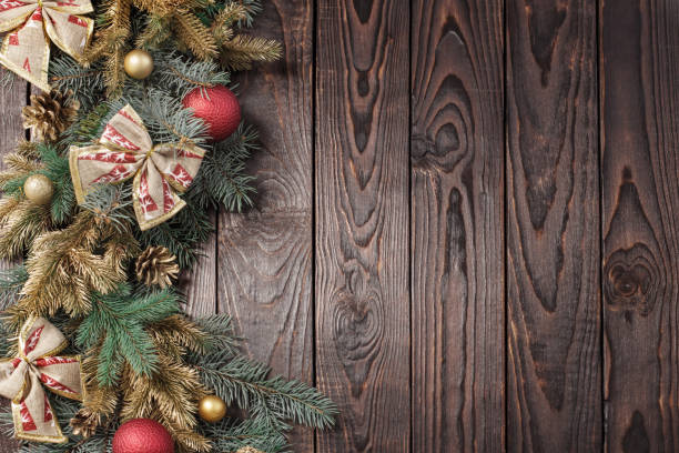 istock fir branches with Christmas decor on old dark wooden background 1282606774